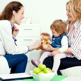 A doctor examining a toddler held by a parent, stock illustration